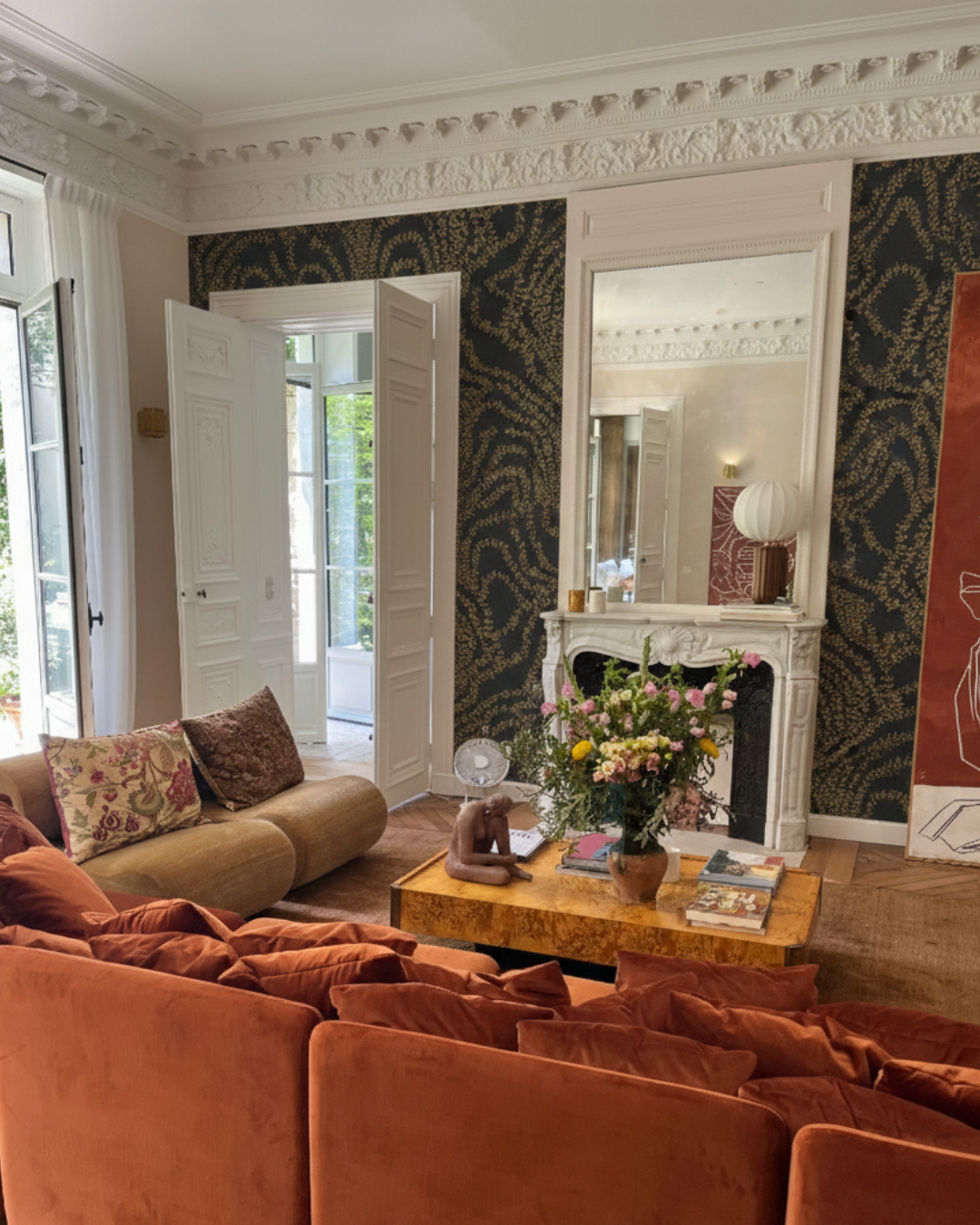 Living Room With Fireplace, Orange Sofa And Bold Organic Wallpaper